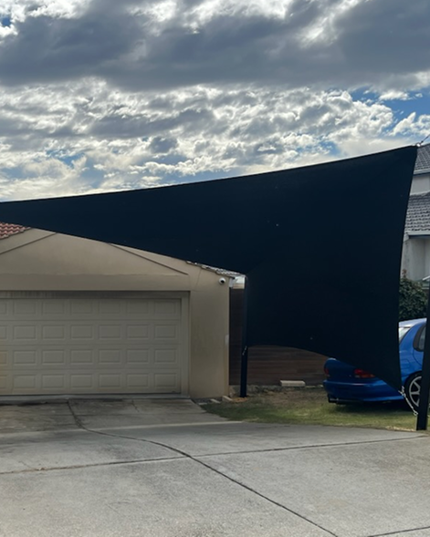 A custom-made shade sail over a carport