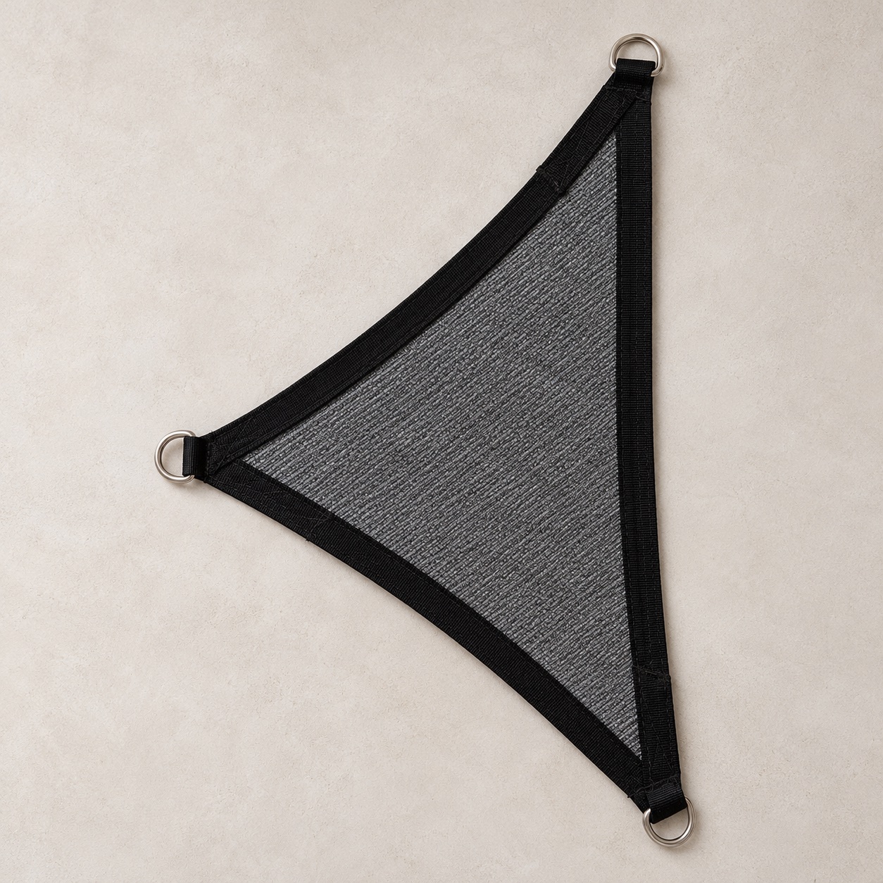 Triangle shade sail, charcoal, laid flat with stainless D-rings