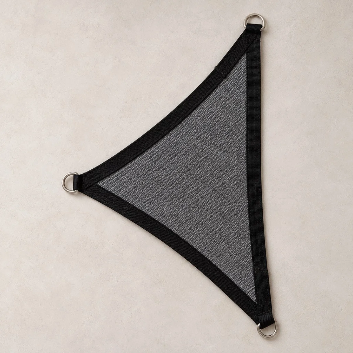 Triangle shade sail, charcoal, laid flat with stainless D-rings